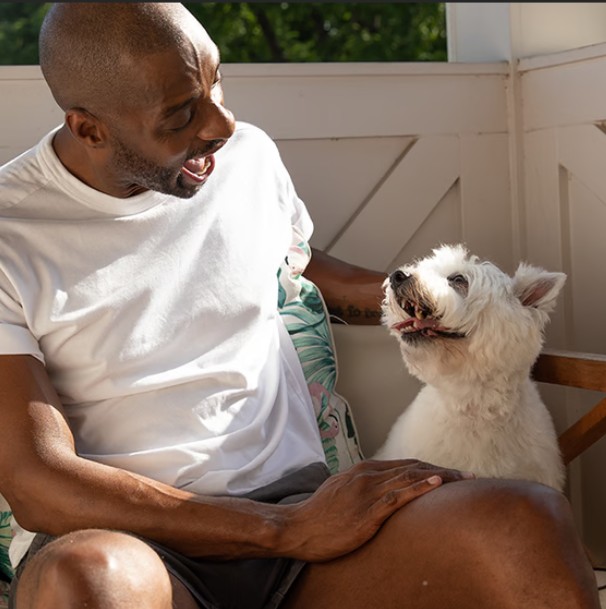 Happy dog smiling at human dad